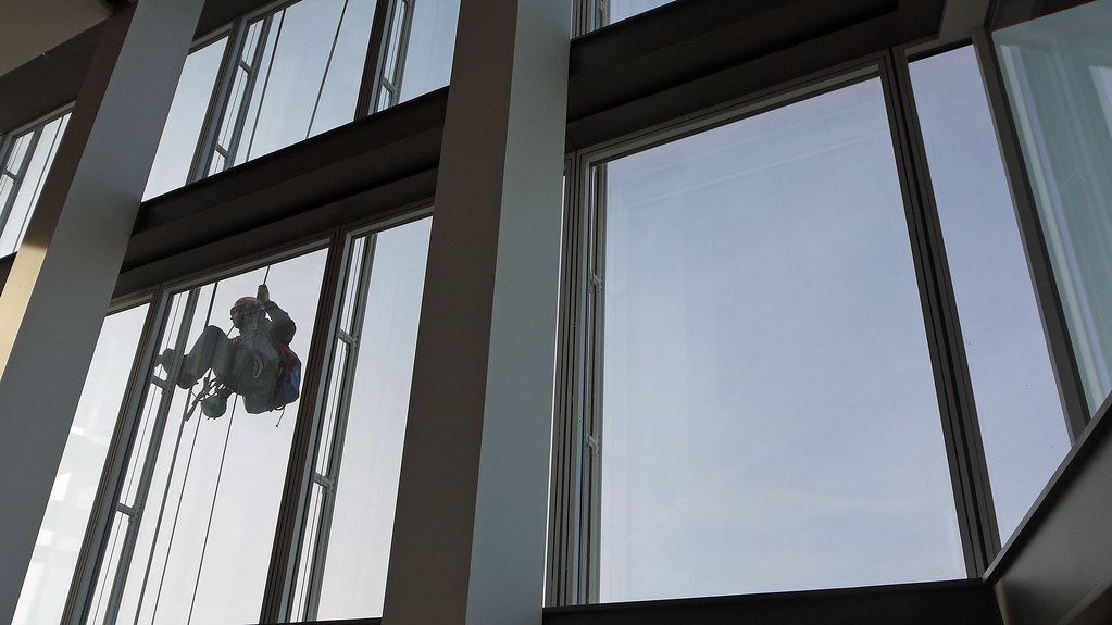 Window cleaner working on large glass panes